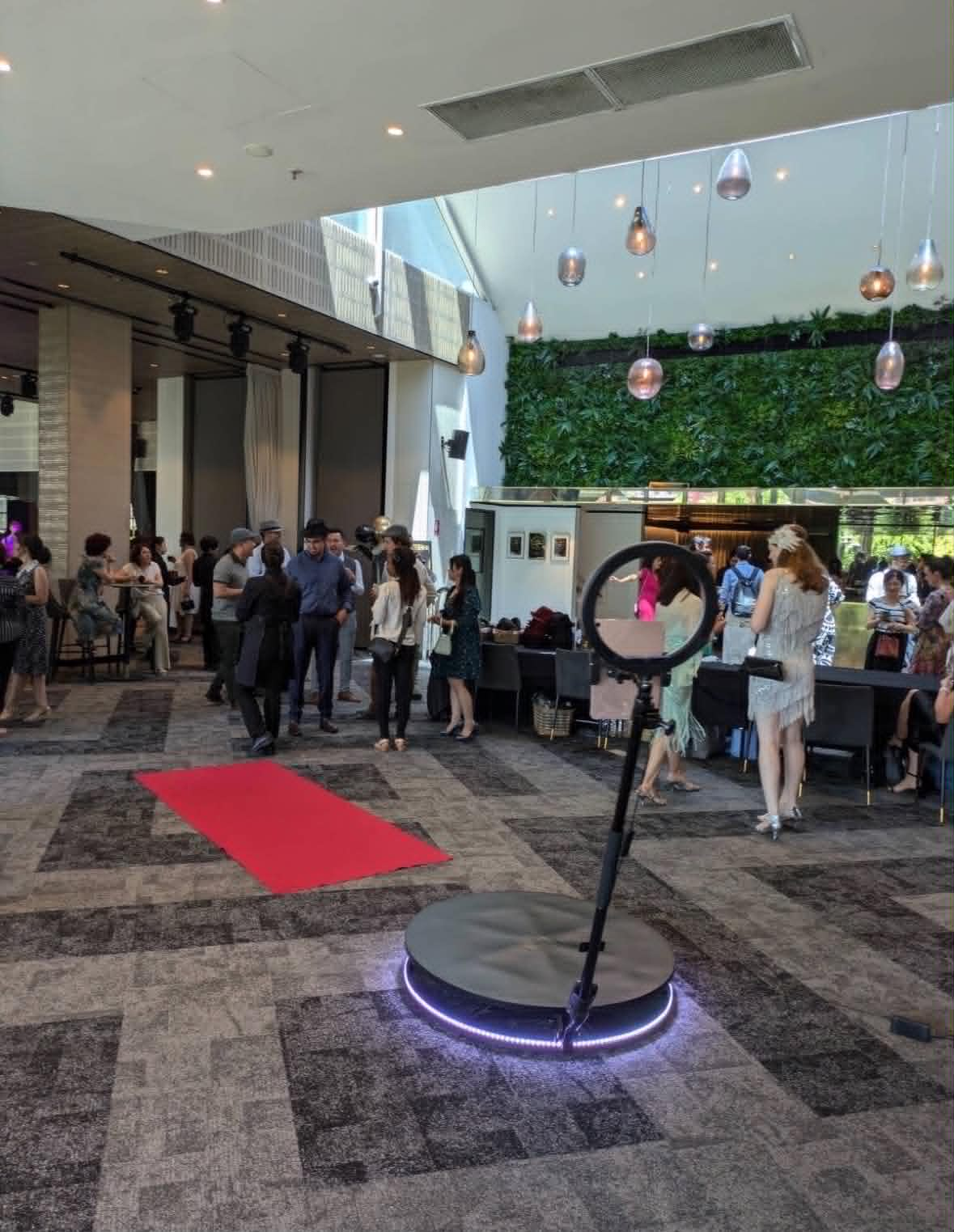 360 photo booth beside a red carpet in a modern venue