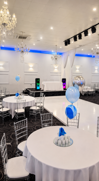Event hall setup with party speakers placed beside the dancefloor