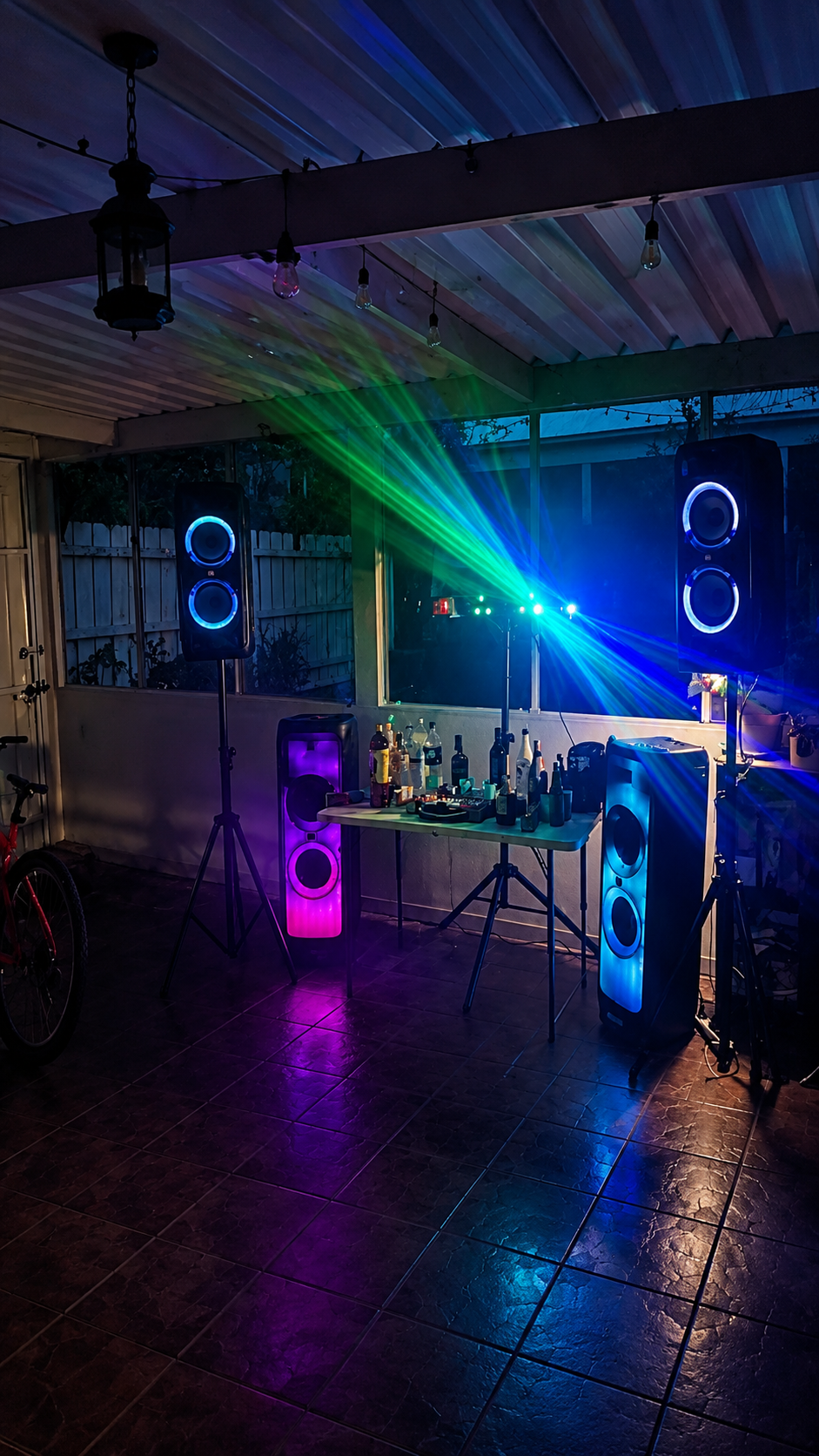Night party speaker setup with laser lighting and glowing speaker rings