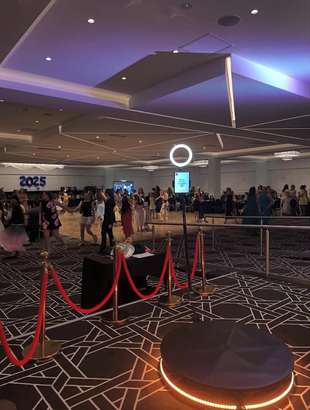 360 photo booth setup in a ballroom with guests on the dancefloor